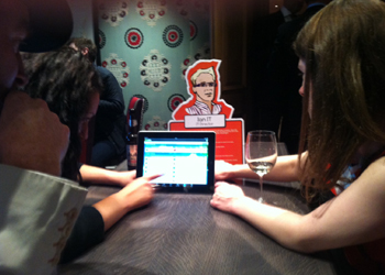 People looking at a screen in front of a cardboard cutout of a man