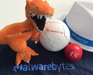 A plush T-Rex next to a ball and a hat - Marketeers