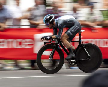 A cyclist racing in front of a crowd