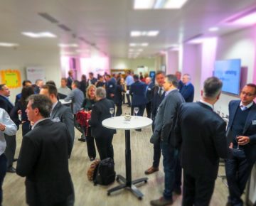 A photo of conference attendees during a break Tech