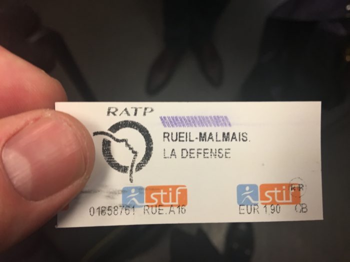 A hand holding a French public transport ticket
