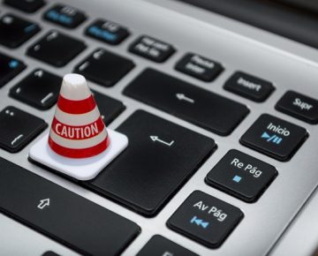 Picture of a cone labeled 'caution' on an apple mac laptop Data