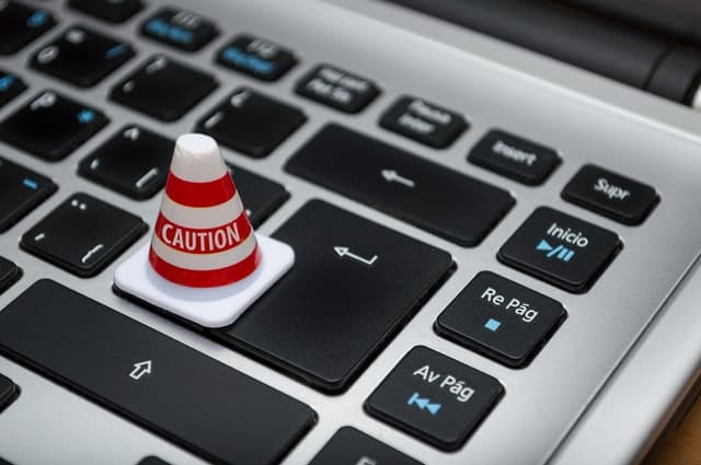 Picture of a cone labeled 'caution' on an apple mac laptop Data