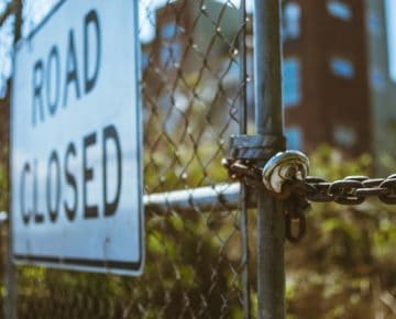 A "road closed" sign on a wire gate GDPR