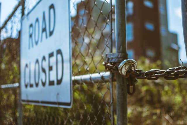 A "road closed" sign on a wire gate GDPR